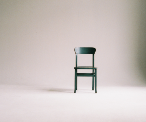 single chair in empty room - dragging your own chair