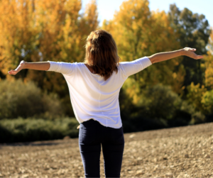 woman standing with arms wide open - joy