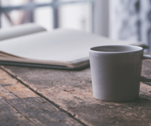 cup and journal on kitchen table